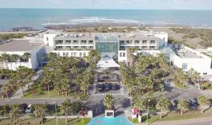 an aerial view of a resort with a pool and palm trees at The View Bouznika in Bouznika