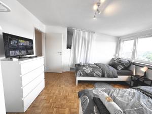a bedroom with two beds and a flat screen tv at # VAZ Apartments RS03 WLAN,TV, Küche, Parking, Autobahnähe in Remscheid