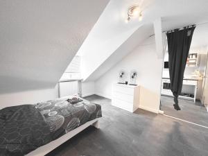 a attic bedroom with a bed and a staircase at # VAZ Apartments RS03 WLAN,TV, Küche, Parking, Autobahnähe in Remscheid