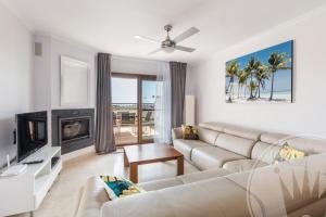 a living room with a couch and a fireplace at La Manga Club Resort - Buena Vista 596 in Atamaría