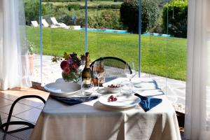 a table with a white table cloth and flowers on it at Villa Anastasia in Cugnana