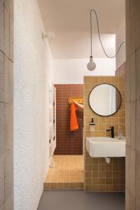 a bathroom with a sink and a mirror at SOMTU design apartments in Liptovský Ján +15 photos