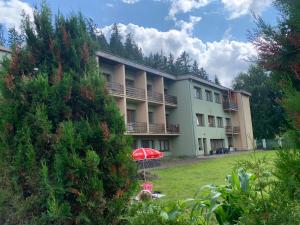 a large building with a yard in front of it at SOMTU design apartments in Liptovský Ján
