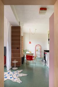 a living room with a table and a red chair at SOMTU design apartments in Liptovský Ján