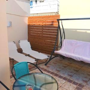 a room with a bed and a table and chairs at Estrella Studios in Chania Town