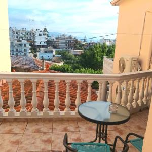 a balcony with a table and a view of a city at Estrella Studios in Chania