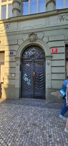 a building with a black door with graffiti on it at Historic Centre Apartments V in Prague
