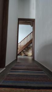 a hallway with a stairway leading to a room at Heliophilia Malona in Malona Village +8 photos