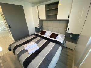 a bedroom with two beds with towels on them at Floating house ARENA 3 in Pula