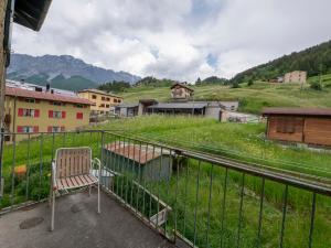 a chair sitting on top of a balcony at New flat in Bormio - Centrale 69 in Piatta
