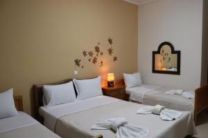 a hotel room with two beds with bows at Kotza Ntere in Axioúpolis
