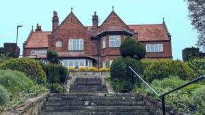 a house with stairs in front of it at Cober Hill in Scarborough