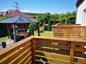 a wooden deck with an umbrella on top of it at Ferienwohnung Hermann in Bovenden