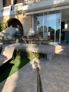 a patio with tables and chairs in a building at Casa Cadi in Orihuela Costa