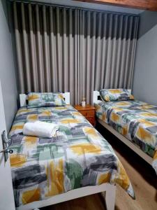 a bedroom with two beds and a window at 20 Brandersig in Jeffreys Bay +5 photos