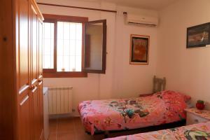 a small bedroom with two beds and a window at Villa Soluna in Cantoria