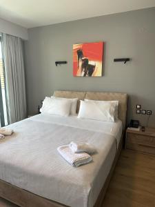una camera da letto con un grande letto e un asciugamano di The Victoria Lefkada a Città di Lefkada