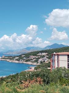 a view of a city and the ocean with mountains at Apartmani LJUBICA in Utjeha