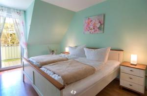 オストゼーバート・ディアーハーゲンにあるSEESTERN App Nr 12 max 6 Persのベッドルーム1室(ランプ2つ、窓付)