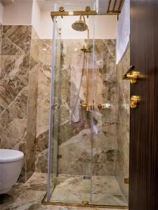 a shower with a glass door in a bathroom at Hotel Boka in Tirana