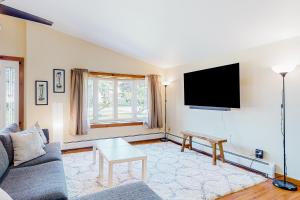 a living room with a couch and a flat screen tv at Sherry Road Retreat in South Burlington