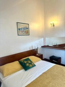 a bedroom with a bed with a pillow on it at Villa Slika in Milna