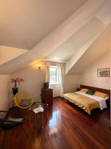 a attic bedroom with a bed and a window at Villa Slika in Milna