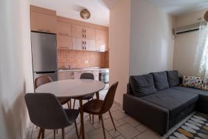 a kitchen and a living room with a table and a couch at Apartment Xenia in Petrovac na Moru +19 photos