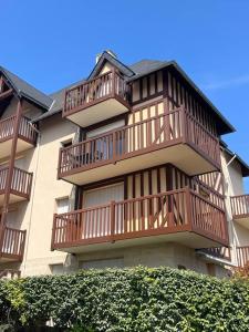 a large building with balconies on the side of it at Côté Plage & Balcon in Cabourg