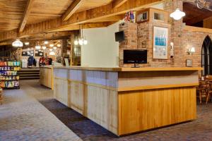 a restaurant with a large counter in a building at Ramada by Wyndham Gananoque Provincial Inn in Gananoque