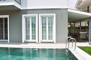 a house with a swimming pool in front of a house at Dalyan Central 4 Bedroom Ensuite Private Villa with Swimming Pool in Dalyan