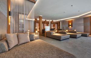 a living room with couches and chairs in a building at Kristall- & Vitalhotel Bergknappenhof in Bodenmais