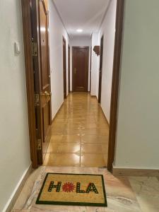 a hallway with a mat in the middle of a room at Puerta del Sol - Plasencia in Plasencia