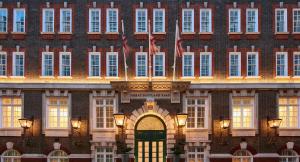 a large brick building with a green door and two flags at Great Scotland Yard Hotel, part of Hyatt in London