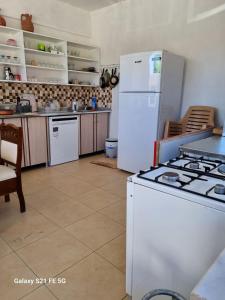 a kitchen with a stove and a white refrigerator at Salda cenneti in Yeşilova