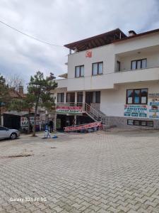 a building with a parking lot in front of it at Salda cenneti in Yeşilova