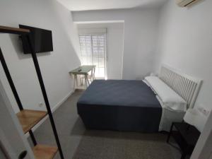 Un ou plusieurs lits dans un hébergement de l'établissement Hostal Acemar