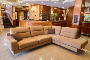 a brown couch sitting in a room at Hotel Miramare in Marina di Varcaturo