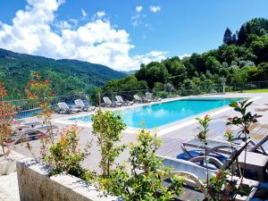 a swimming pool with lounge chairs and a mountain at Solar do Cávado in Vieira do Minho