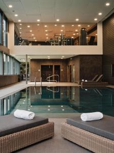 a swimming pool with two beds in a building at Andorra Park Hotel in Andorra la Vella