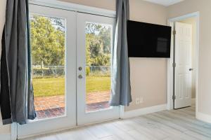 a sliding glass door with a view of a yard at Jacksonville Retreat: Unwind in Style at our Cozy Duplex Apartment in Jacksonville