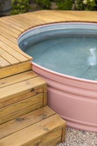 a hot tub sitting on a wooden deck at Camping Miramar in Miami Platja