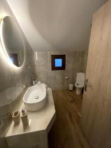 a bathroom with a sink and a toilet at Barbara's House,New Luxury central apartment in Nea Kallikrateia