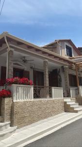 a house with two flower boxes on the front porch at Barbara's House,New Luxury central apartment in Nea Kalikratia