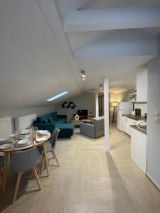 a living room and kitchen with a table and chairs at Barbara's House,New Luxury central apartment in Nea Kallikrateia