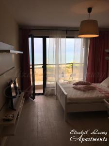 a bedroom with a bed and a view of the ocean at Beachfront Luxury Apartments Elizabeth, Pomorie in Pomorie +151 photos