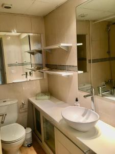 a bathroom with a sink and a toilet at Flamingo in L'Ampolla