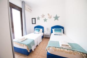 A bed or beds in a room at The Olive Garden-Almyrida