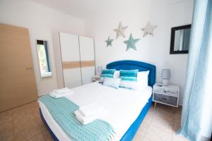 A bed or beds in a room at The Olive Garden-Almyrida