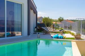 a swimming pool in the backyard of a house at Villa Bella Vista in Vrbnik +48 photos